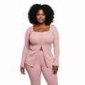 Woman wearing a pink ribbed outfit on a white background